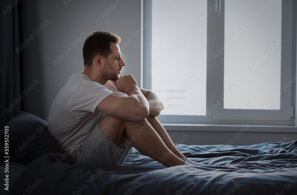 Anxious Man Thinking About Problems Sitting In Bed Indoors - obrazy, fototapety, plakaty 