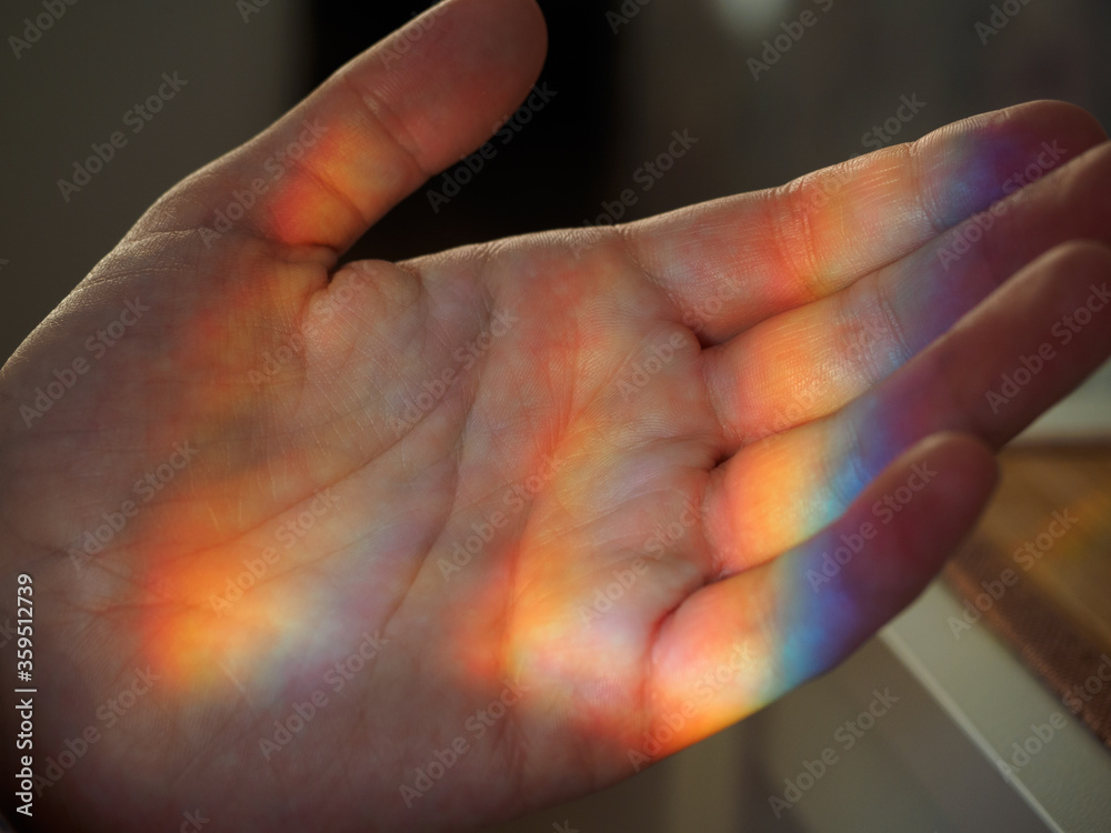 A real rainbow in the palm of your hand, as a symbol of LGBTQ. Concept: catch a rainbow with your hands, be real. Concepts of pride of the LGBT community: lesbian, gay, bisexual, transgender