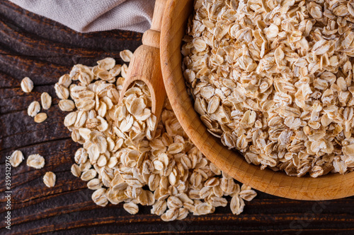 raw oatmeal on a wooden rustic background