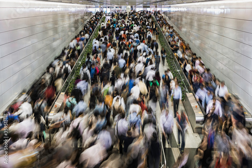 Asia, China, Hong Kong, commuters using subway during morning rush hour in underground train station in financial district photo
