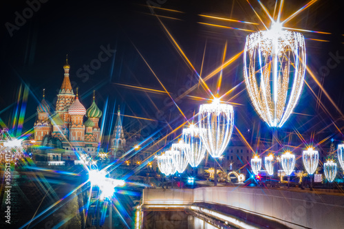 Radiance of new year s garlands. Garlands glow brightly against the dark sky. Moscow is festive. St. Basil s Cathedral. Christmas in Moscow. Christmas city decorations. Travel to Russia.