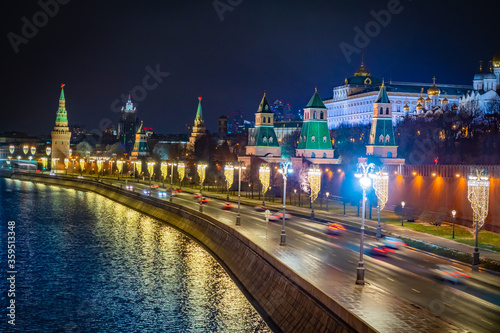 Moscow. Russia. Kremlin embankment in the evening. Lanterns at the Kremlin walls are decorated with garlands. Traffic on the Kremlin embankment. Russia celebrates Christmas. New year in Moscow.