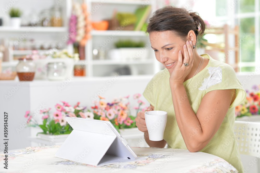 Portrait of beautiful young woman using digital tablet Portrait of beautiful young woman using digital tablet