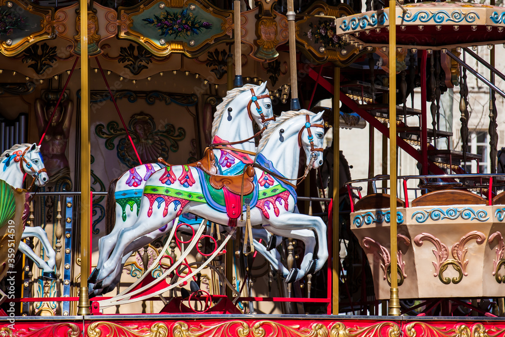 Horses of a French old-fashioned style carousel with stairs in Avignon France