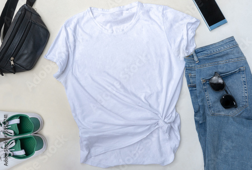 white t-shirt mockup for print. Flatlay with casual clothes. Pants, black sunglasses, white sneakers and shoulder bag