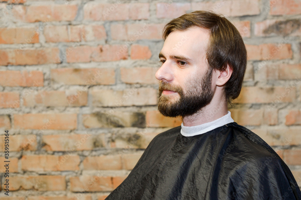 Portrait one freak bearded shaggy man long hair before haircut in barbershop Portrait one freak bearded shaggy man long hair before haircut in barbershop
