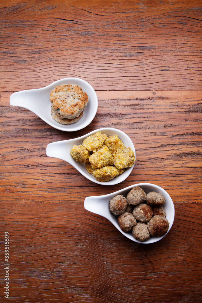 Nutrition concept - Healthy meals in White bowls , hamburguer and meat balls over wooden background. Healthy food, Diet, Detox, Clean Eating or Vegetarian concept. Top view, flat lay.