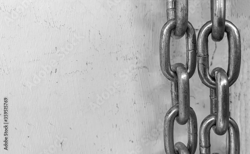 Large chain links on a gray background. The concept of bondage and restriction of freedom. Slavery. Free space for text.