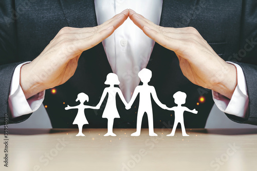 Asian insurance businessmen use their hands to protect the family. White paper.
