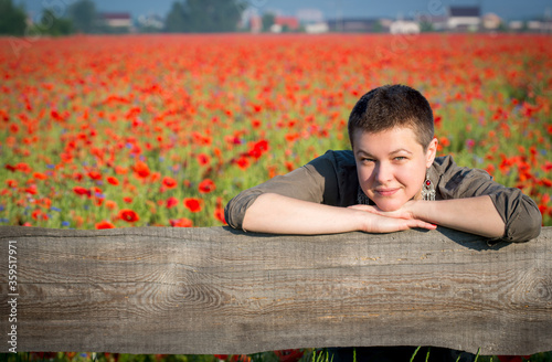 Pretty young woman over poppy flower field © gertrudda