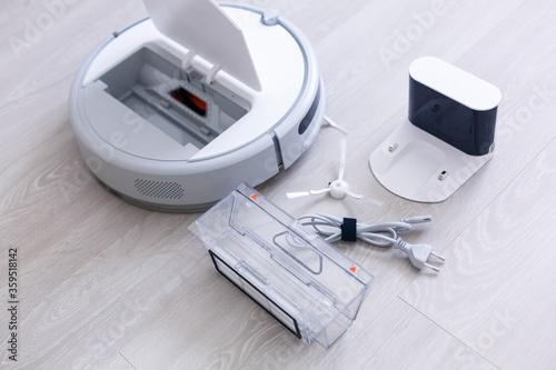 Robotic vacuum cleaner. Container with garbage from a smart robot vacuum cleaner. housework and technology concept