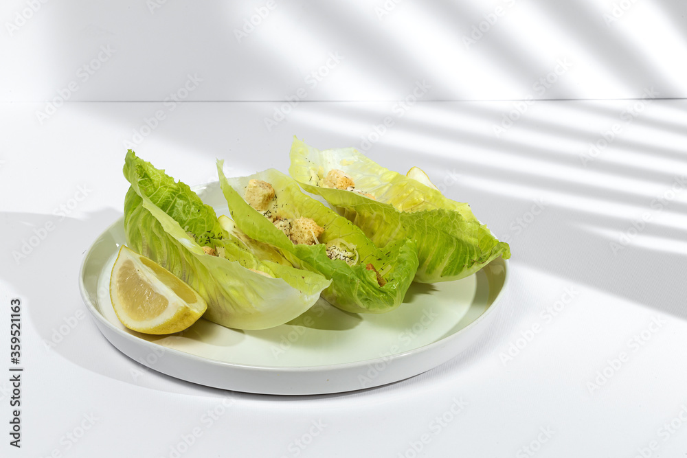 Homemade Caesar salad with chicken, lettuce, lemon, toast, cesar sauce, cheese and garlic Homemade Caesar salad with chicken, lettuce, lemon, toast, cesar sauce, cheese and garlic