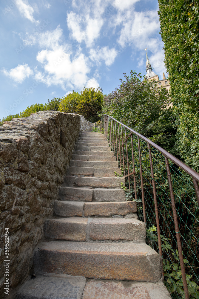 Steep stone stairs in Mont Saint-Michel, the monastery and village on a tidal island between Brittany and Normandy, France