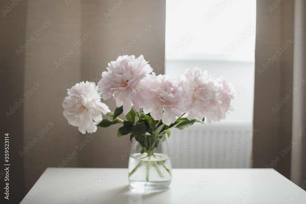 Beautiful pink peonies in a vase at home interior. Flower composition. Floral shop concept. Beautiful fresh cut bouquet. copyspace Beautiful pink peonies in a vase at home interior. Flower composition. Floral shop concept. Beautiful fresh cut bouquet. copyspace