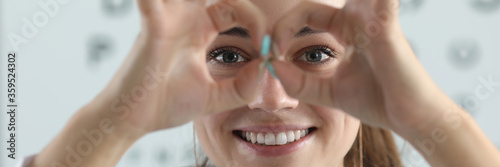 Konstfotografi Portrait of smiling pretty eye doctor having fun in office