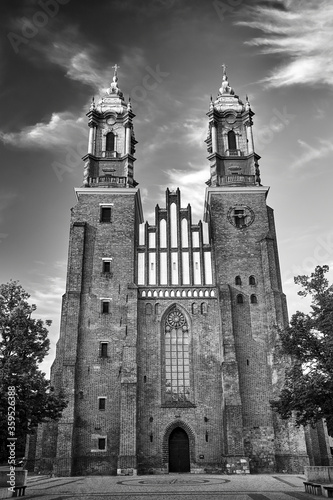 Gothic facade and bell towers of the historic Poznan cathedral  black and white.