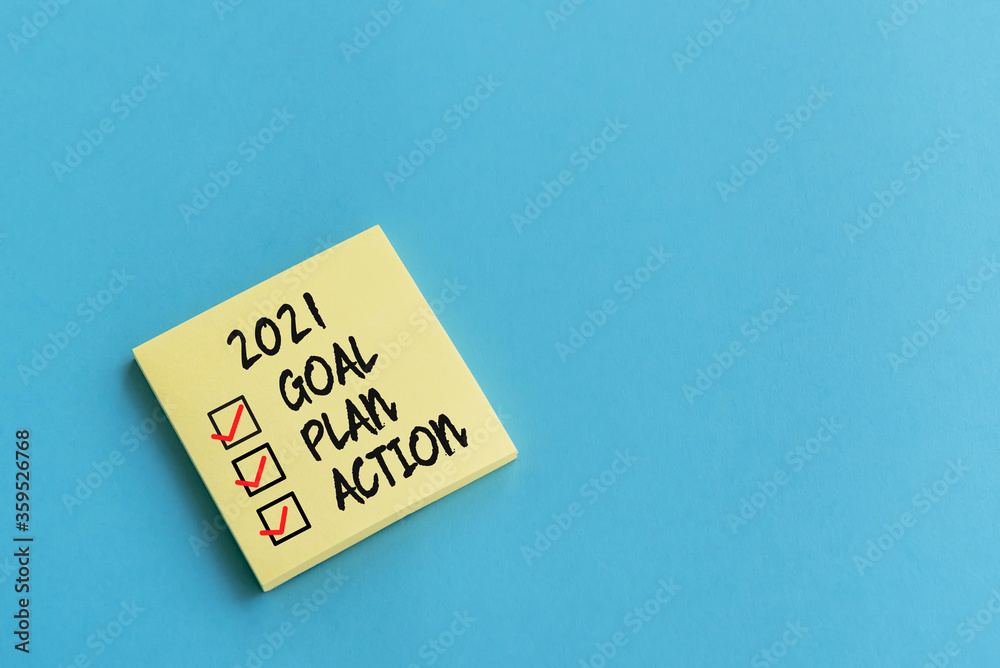 2021 goal, plan, action checklist text on adhesive note blue background 2021 goal, plan, action checklist text on adhesive note blue background