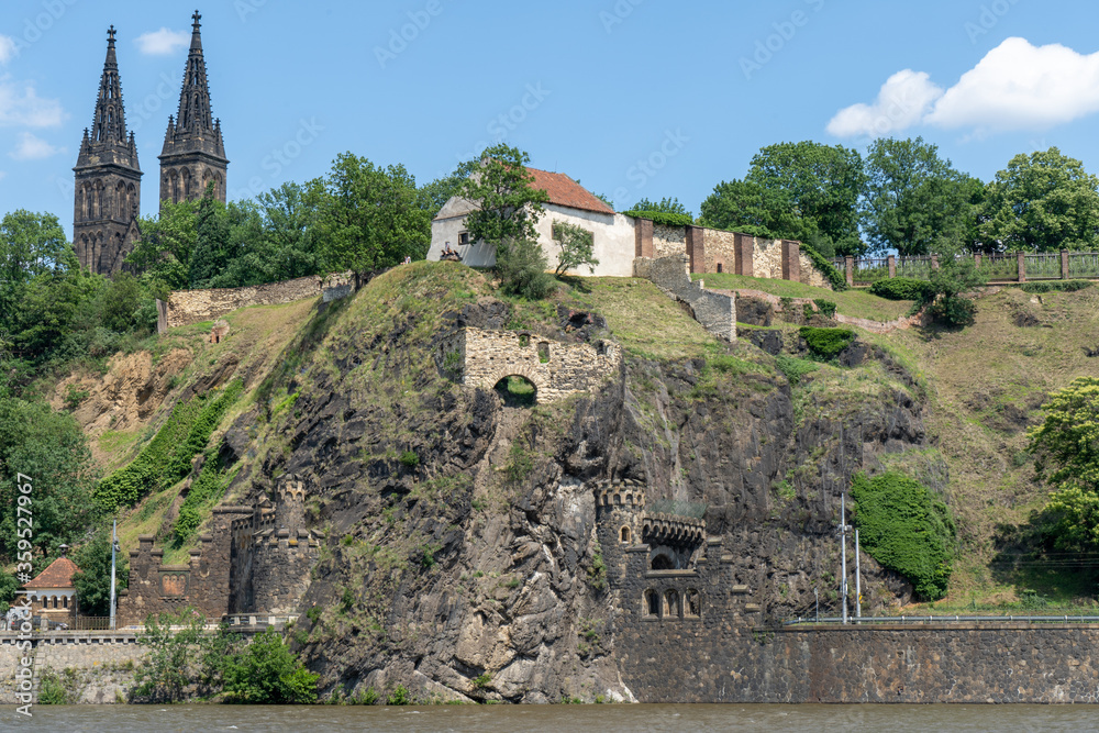 flowing river Vltava under the old fortress Vyšehrad and the Basilica of St. Peter and Paul in Prague. There is a tunnel under the fortress. in the summer in the center 