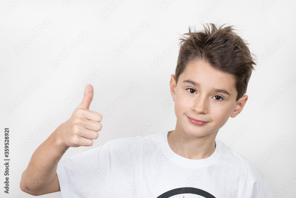 Teenage boy in white shirt. Portrait in studio. Funny faces.