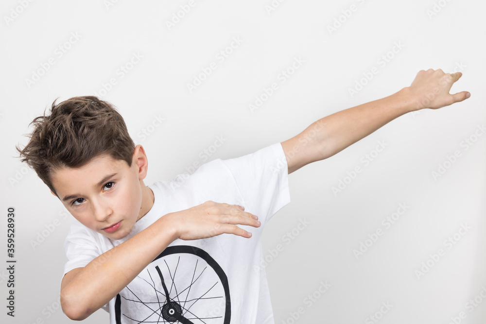 Teenage boy in white shirt. Portrait in studio. Funny faces.