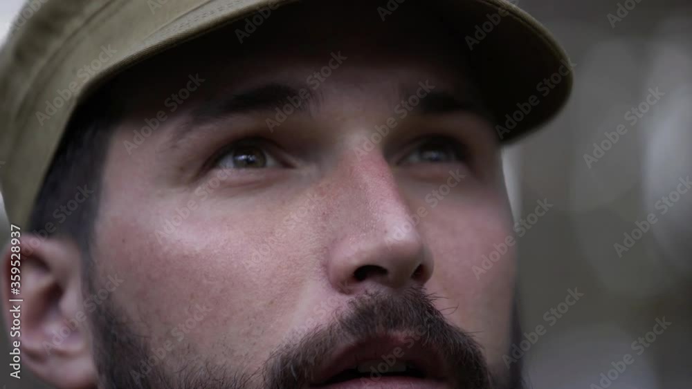 Portrait of handsome young man hunter blows in decoy and lures fowl. Man in camouflage clothes hunts outdoor in forest hunting alone. Close up of man hiker standing in forest. Hunter hunts down prey Portrait of handsome young man hunter blows in decoy and lures fowl. Man in camouflage clothes hunts outdoor in forest hunting alone. Close up of man hiker standing in forest. Hunter hunts down prey
