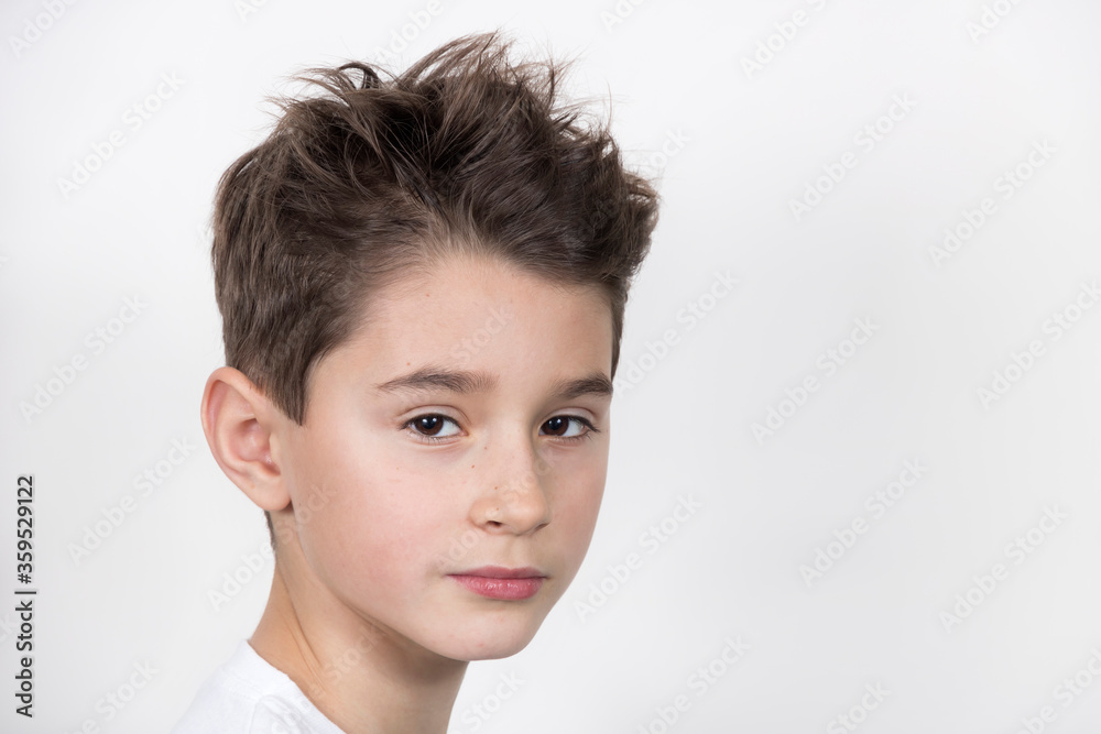 Teenage boy in white shirt. Portrait in studio. Funny faces.
