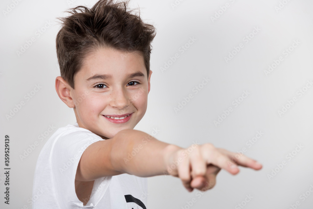 Teenage boy in white shirt. Portrait in studio. Funny faces.