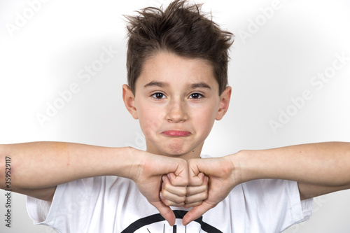 Teenage boy in white shirt. Portrait in studio. Funny faces.