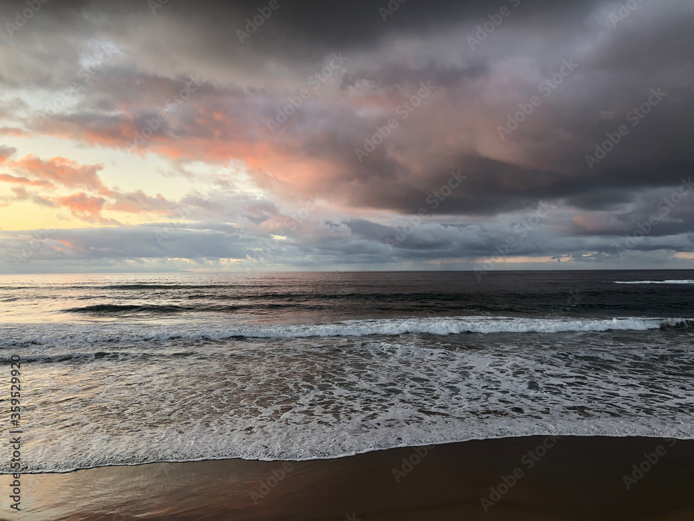 Dark clouds above Las Canteras beach during sunset in Las Palmas