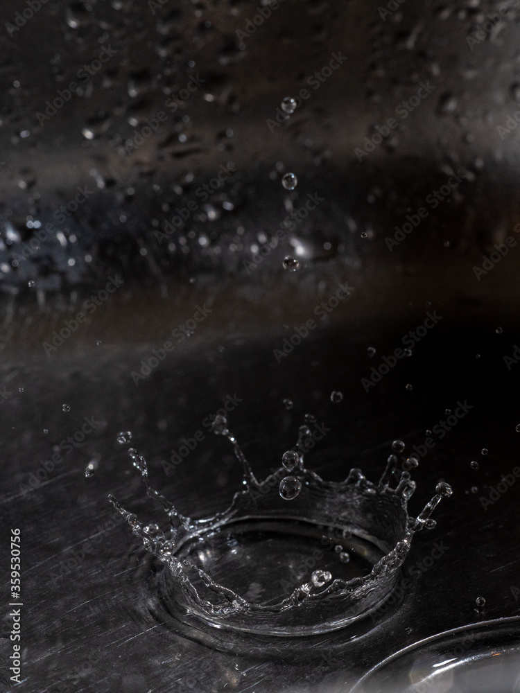 Drop of water falling on a sink Drop of water falling on a sink