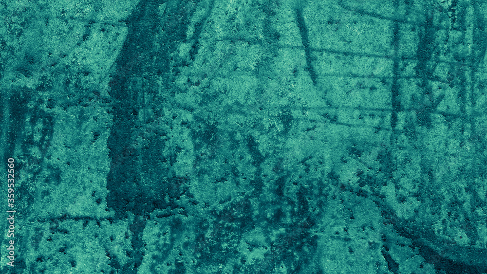 Blue green background with old vintage grunge texture; abstract rough wall design with grungy paint spatter and scratches in elegant teal color