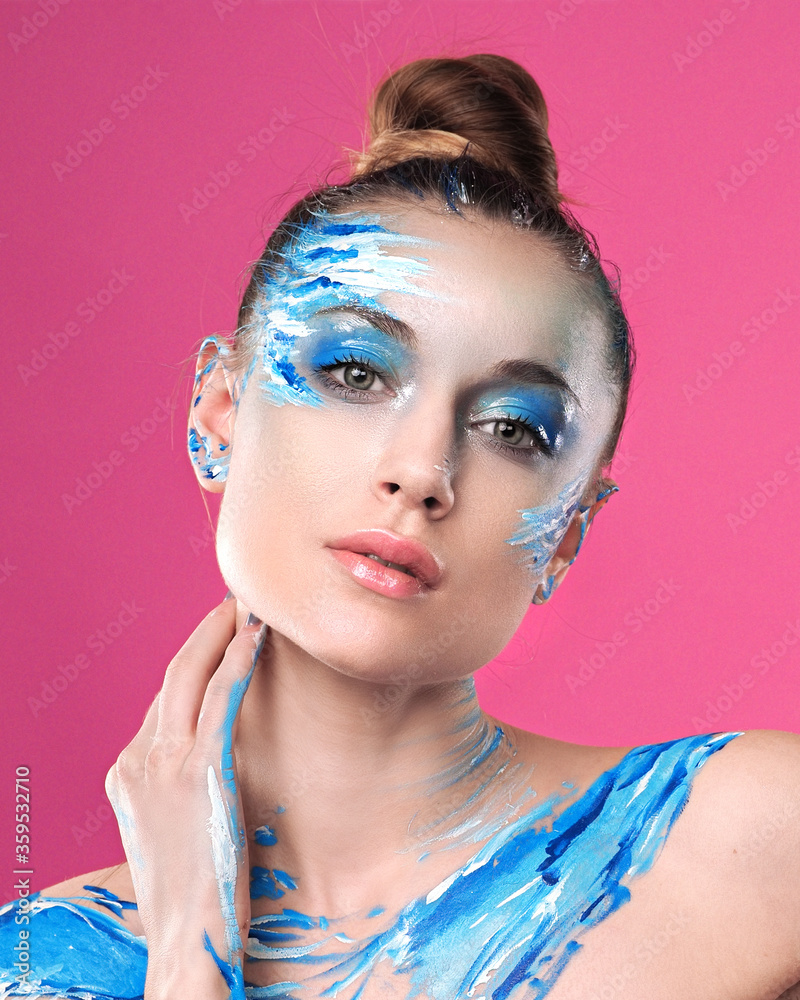 Girl with art make up posing at pink background Girl with art make up posing at pink background