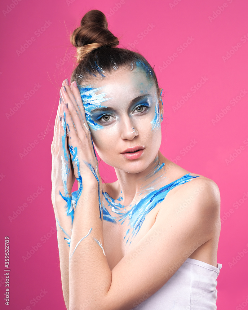 Girl with art make up posing at pink background Girl with art make up posing at pink background