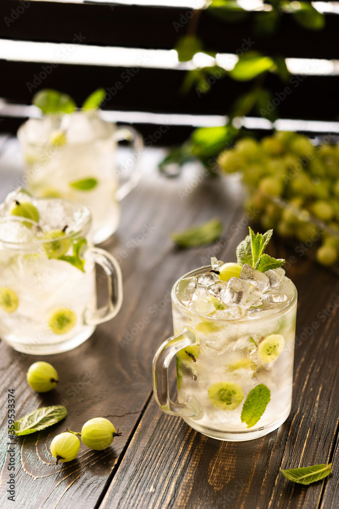 Cold summer drink with green gooseberries and mint, lemonade with ice Cold summer drink with green gooseberries and mint, lemonade with ice