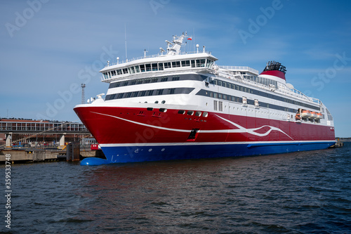Large red and white passenger RORO-ferry docked at the harbour. © Marko Hannula