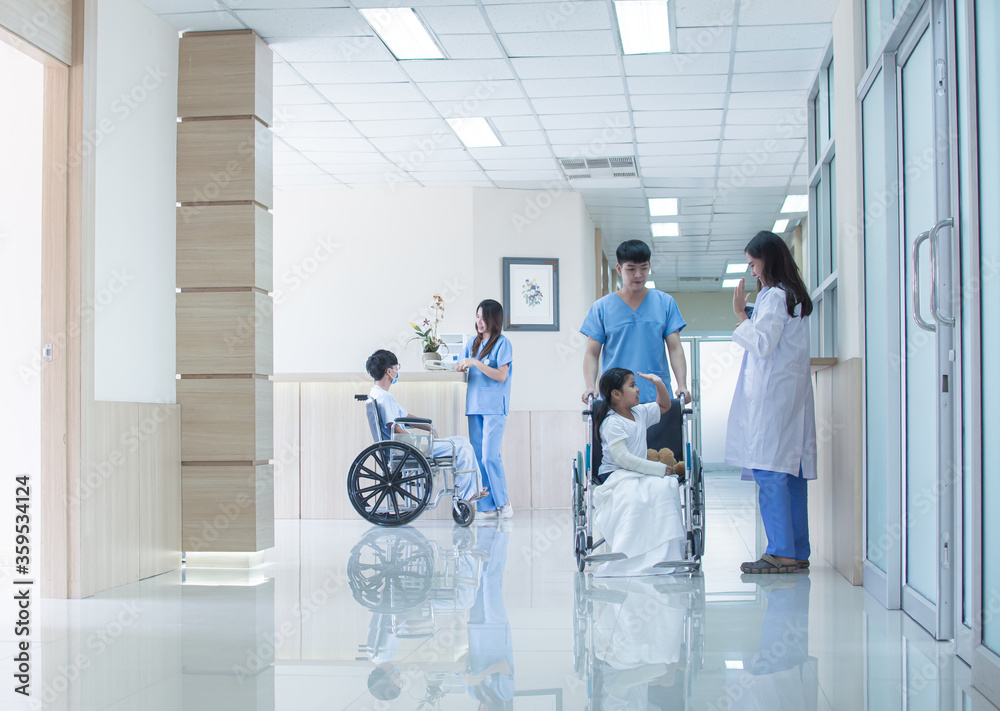 Fototapeta premium Doctors and patients at hallway of hospital