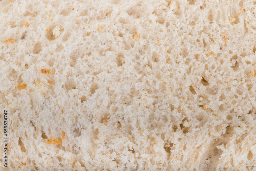 Slice of white Bread skin surface texture pattern close up detail macro. Abstract background.