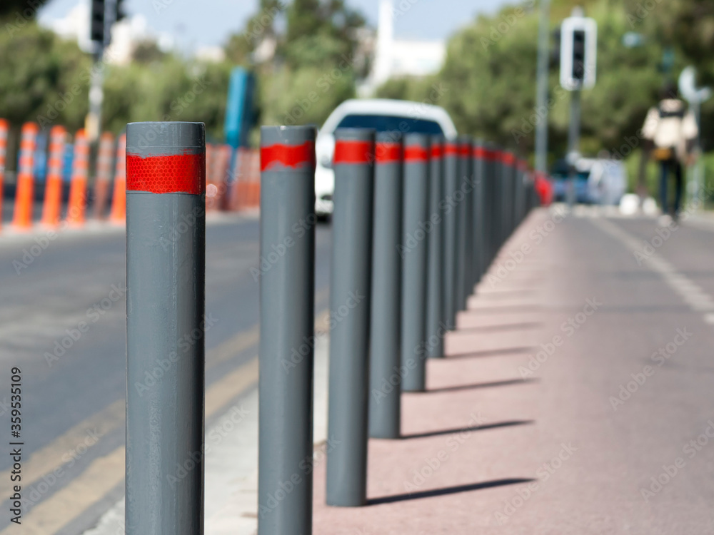 Row of street bollards on the road