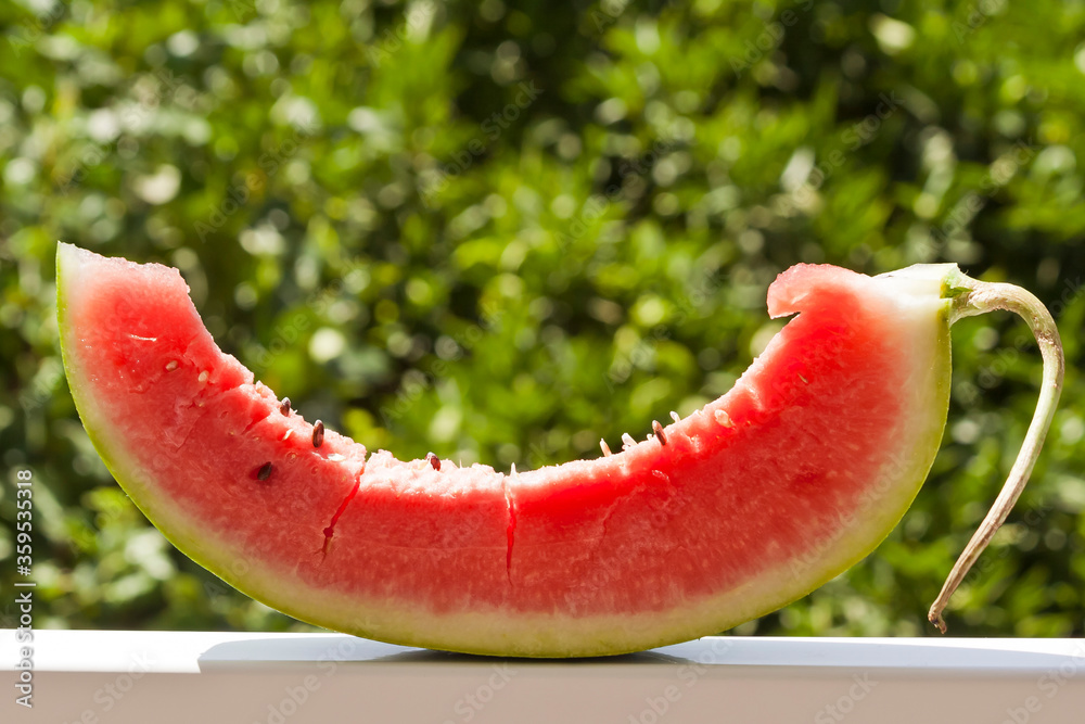 red watermelon on white table on green background red watermelon on white table on green background