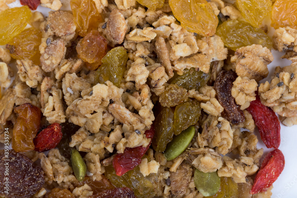 Top View Close up Mixture of granola or muesli on white background, dehydrated fruit mix, healthy food, almond, sun dried cultivated banana, cranberry, cashew nut, pumpkin, melon seed Top View Close up Mixture of granola or muesli on white background, dehydrated fruit mix, healthy food, almond, sun dried cultivated banana, cranberry, cashew nut, pumpkin, melon seed