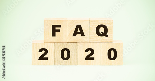 letters faq and number twentieth year on wooden blocks