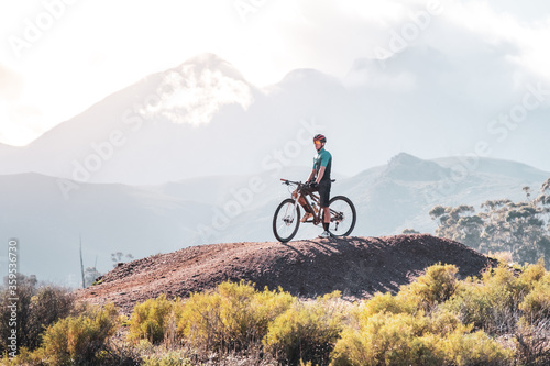 mountain biker resting on top of a mound