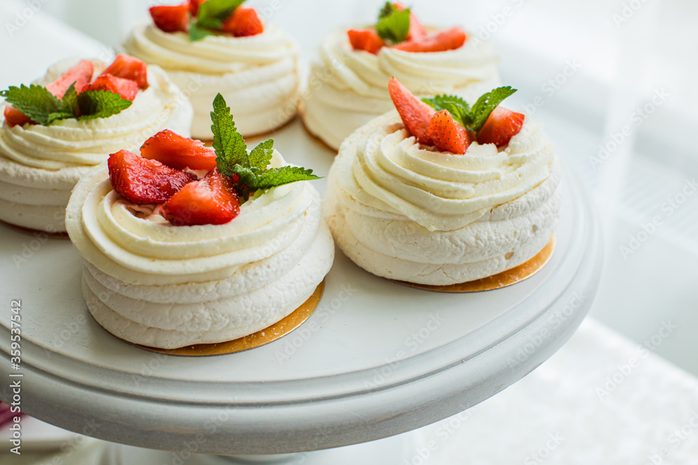 The tender meringue cakes with strawberries and mint The tender meringue cakes with strawberries and mint