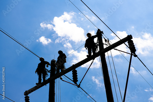 linemen utility workers on power lines
