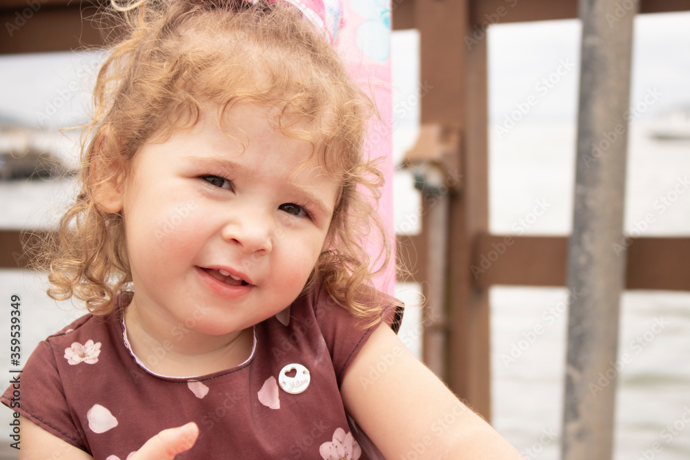 Curly blond hair girl smiling. Goldilocks Curly blond hair girl smiling. Goldilocks