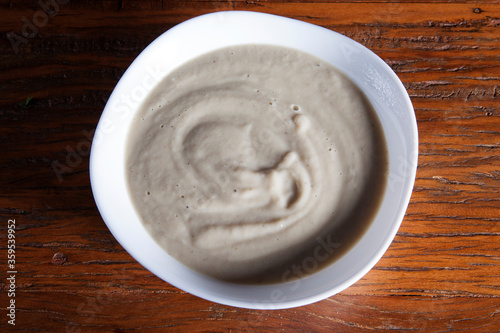 Nutrition concept - Healthy meals in White bowls over wooden background. Healthy food  Diet  Detox  Clean Eating or Vegetarian concept. Delicious soup made of mushrooms.