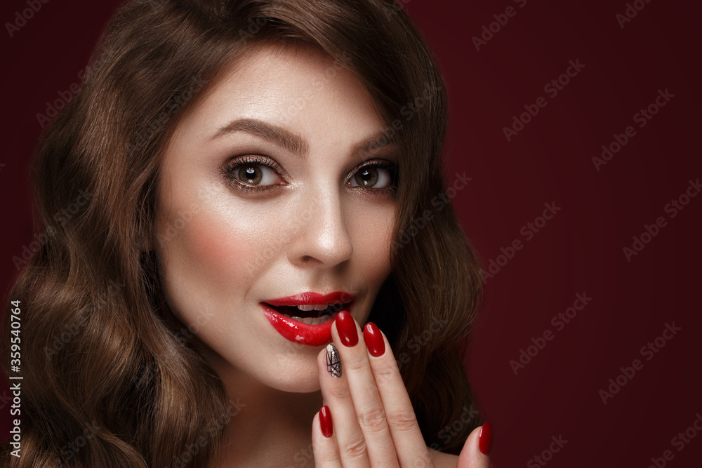 Beautiful girl with a classic make up, curls hair and red nails. Manicure design. Beauty face. Beautiful girl with a classic make up, curls hair and red nails. Manicure design. Beauty face.