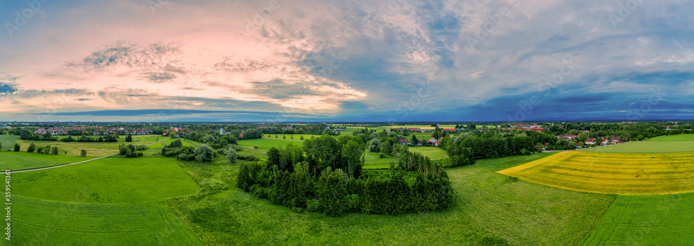 Beautiful panoramic aerial view over a countryside sunrise with fields and trees in southern germany