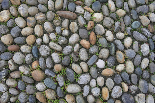 Randomly arranged colored paving stones on the floor as background structure