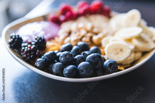 Cereals and fruits superbowl  healthy bowl breakfast with flakes  oat and fruits  raspberries  blueberries  banana  blackberries